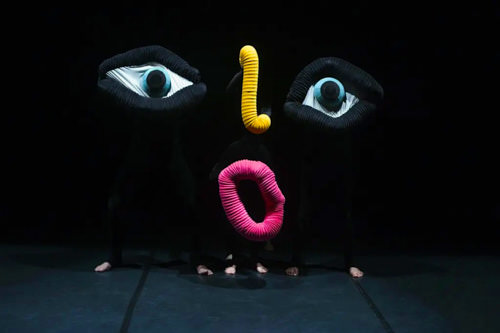 Coloured eyes, mouth and nose in oversized form on theatre stage