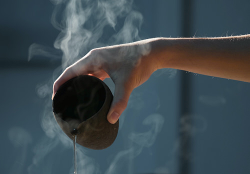 Man's hand puring hot water