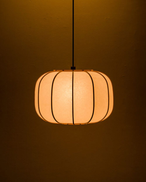 A bamboo and paper lamp reminiscent of a traditional Japanese lantern